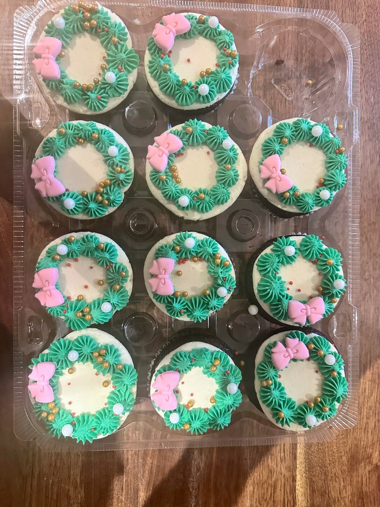 Cupcakes with green frosting wreaths and pink bows