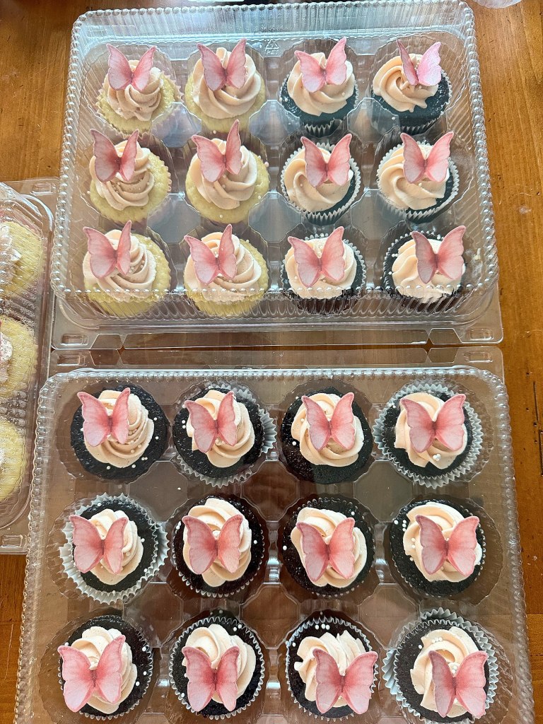 Vanilla and chocolate cupcakes with pink frosting and pink butterflies