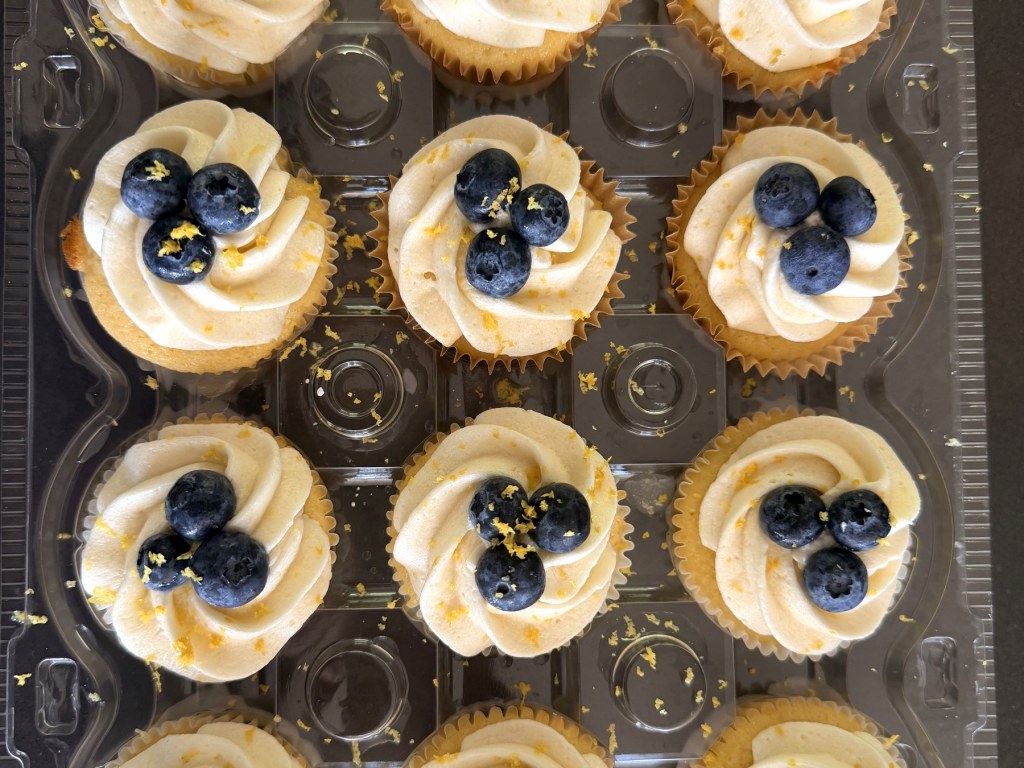 Vanilla cupcakes topped with fresh blueberries and lemon zest